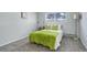 Cozy bedroom with lime green bedding and ample closet space at 14602 E 2Nd Ave # 100C, Aurora, CO 80011