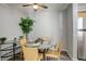 Small dining area with round table and four yellow chairs at 14602 E 2Nd Ave # 100C, Aurora, CO 80011