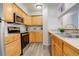 Galley kitchen with light wood cabinets and stainless steel appliances at 14602 E 2Nd Ave # 100C, Aurora, CO 80011