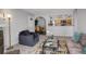 Open living room, dining area, and kitchen with modern appliances at 14602 E 2Nd Ave # 100C, Aurora, CO 80011