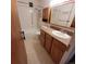 Bathroom featuring a tub-shower combo, oak vanity, and a well-lit mirror cabinet at 755 S Clinton St # 1B, Denver, CO 80247