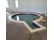Inviting indoor hot tub with tiled surround and steps for easy access at 755 S Clinton St # 1B, Denver, CO 80247