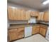 Kitchen showcasing light wood cabinets and speckled countertops, complete with modern appliances at 755 S Clinton St # 1B, Denver, CO 80247