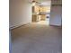 Spacious living room showcasing the carpet, ceiling fan, and the open layout to the kitchen area with white appliances at 755 S Clinton St # 1B, Denver, CO 80247