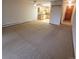 Bright living room with carpet, ceiling fan and view into the open kitchen and hallway with door at 755 S Clinton St # 1B, Denver, CO 80247