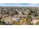 Scenic aerial view of a home highlighting its backyard, the surrounding neighborhood, and mature landscaping at 10385 E Ida Ave, Greenwood Village, CO 80111