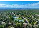 Panoramic aerial view showcasing the community, mature trees, a pool, and a tennis court at 10385 E Ida Ave, Greenwood Village, CO 80111