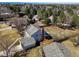 Aerial view of a home showcasing its spacious backyard, patio, and mature trees at 10385 E Ida Ave, Greenwood Village, CO 80111