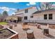 Spacious backyard featuring a covered patio, a fire pit area, and garden beds at 10385 E Ida Ave, Greenwood Village, CO 80111