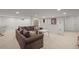 Spacious finished basement offers a cozy seating area with plush carpet flooring at 10385 E Ida Ave, Greenwood Village, CO 80111