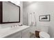 Clean bathroom with modern fixtures, white vanity, and framed mirror at 10385 E Ida Ave, Greenwood Village, CO 80111