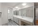 Bright bathroom features a long vanity, large mirror and neutral color scheme at 10385 E Ida Ave, Greenwood Village, CO 80111