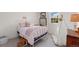 Charming bedroom with a white bed frame, playful decor, and soft carpet at 10385 E Ida Ave, Greenwood Village, CO 80111