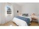 Comfortable bedroom with light wood floors, white walls, and a large window at 10385 E Ida Ave, Greenwood Village, CO 80111