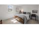 Neutral bedroom with a full size bed, white walls, carpeted floor and large window at 10385 E Ida Ave, Greenwood Village, CO 80111