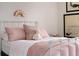 Cute bedroom with a white metal frame bed, plaid bedding, and a rainbow wall decoration at 10385 E Ida Ave, Greenwood Village, CO 80111