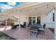 Inviting covered patio with string lights, dining table and chairs, and comfortable seating area at 10385 E Ida Ave, Greenwood Village, CO 80111