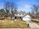 Charming two-story home with a well-manicured lawn, inviting front porch, and attached two-car garage at 10385 E Ida Ave, Greenwood Village, CO 80111