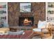 Close-up of a stone fireplace with built-in bookshelves and cozy decor at 10385 E Ida Ave, Greenwood Village, CO 80111