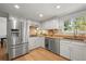 Bright kitchen with stainless steel appliances, granite countertops, and hardwood flooring at 10385 E Ida Ave, Greenwood Village, CO 80111