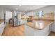 Well-lit kitchen with stainless steel appliances, granite countertops, and hardwood flooring at 10385 E Ida Ave, Greenwood Village, CO 80111