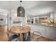 Open kitchen and dining area with hardwood floors and modern lighting at 10385 E Ida Ave, Greenwood Village, CO 80111
