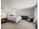 Main bedroom with a canopy bed, dark wood furniture and a neutral color palette at 10385 E Ida Ave, Greenwood Village, CO 80111
