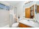 Bathroom featuring a shower/tub combo with modern shower curtain and wood vanity at 13504 Pecos St, Westminster, CO 80234