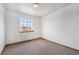 Empty bedroom featuring neutral carpet, a ceiling light, a large window, and white walls at 13504 Pecos St, Westminster, CO 80234
