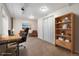 This is a bedroom with a desk, shelves, closet, and an adjacent sitting area with stylish decor at 13504 Pecos St, Westminster, CO 80234