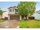 Charming two-story home with a well-manicured lawn and a spacious driveway leading to a two-car garage at 13504 Pecos St, Westminster, CO 80234