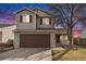 Two-story home featuring a two-car garage, well-maintained lawn, and landscaping at 13504 Pecos St, Westminster, CO 80234