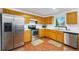 Functional kitchen features stainless steel appliances, wood cabinets, ample counter space, and bright natural lighting at 13504 Pecos St, Westminster, CO 80234