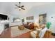 Cozy living room with a fireplace, comfortable seating, hardwood floors, and a decorative rug at 13504 Pecos St, Westminster, CO 80234