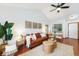 Bright living room with vaulted ceilings, hardwood floors, comfortable leather seating, and a large window at 13504 Pecos St, Westminster, CO 80234