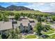 Scenic aerial view of the townhouse nestled in a lush green neighborhood with a stunning mountain backdrop at 19 Benthaven Pl, Boulder, CO 80305