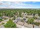 Aerial view of townhomes with solar panels amid tree-lined streets at 19 Benthaven Pl, Boulder, CO 80305