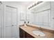 Bathroom featuring a granite countertop, a bright mirror, and plenty of storage at 19 Benthaven Pl, Boulder, CO 80305