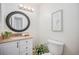Well lit bathroom with an oval mirror, granite countertop and seahorse art at 19 Benthaven Pl, Boulder, CO 80305