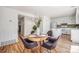 Charming dining area next to the kitchen, featuring a wood table, stylish chairs, and ample natural light at 19 Benthaven Pl, Boulder, CO 80305