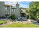 Charming townhouse showcasing a welcoming front exterior, landscaped yard, and inviting entrance with seating at 19 Benthaven Pl, Boulder, CO 80305