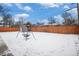 Spacious backyard with a swing set and snow covering at 460 Iola St, Aurora, CO 80010