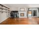 Living room with hardwood floors, fireplace, and built-in shelving at 460 Iola St, Aurora, CO 80010