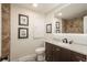 Updated bathroom with mosaic tile details, framed art, stylish vanity and updated fixtures at 8170 S Marshall Ct, Littleton, CO 80128