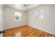 Bright bedroom with hardwood floors, neutral walls, ceiling fan, and dual windows providing natural light at 8170 S Marshall Ct, Littleton, CO 80128