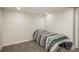 Bedroom featuring carpet floors, white walls, and a comfortable bed with striped bedding at 8170 S Marshall Ct, Littleton, CO 80128