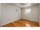 A bedroom featuring natural light from two windows, and complemented by classic hardwood floors at 8170 S Marshall Ct, Littleton, CO 80128