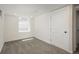 Bright bedroom featuring neutral walls, carpeted floors, and a window bringing in natural light at 8170 S Marshall Ct, Littleton, CO 80128