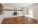 Spacious living room with hardwood floors, white painted brick fireplace, and sliding glass doors at 8170 S Marshall Ct, Littleton, CO 80128