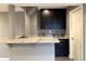 Stylish bar area with dark cabinets, granite countertops, and modern fixtures at 9377 Longstone Dr, Parker, CO 80134